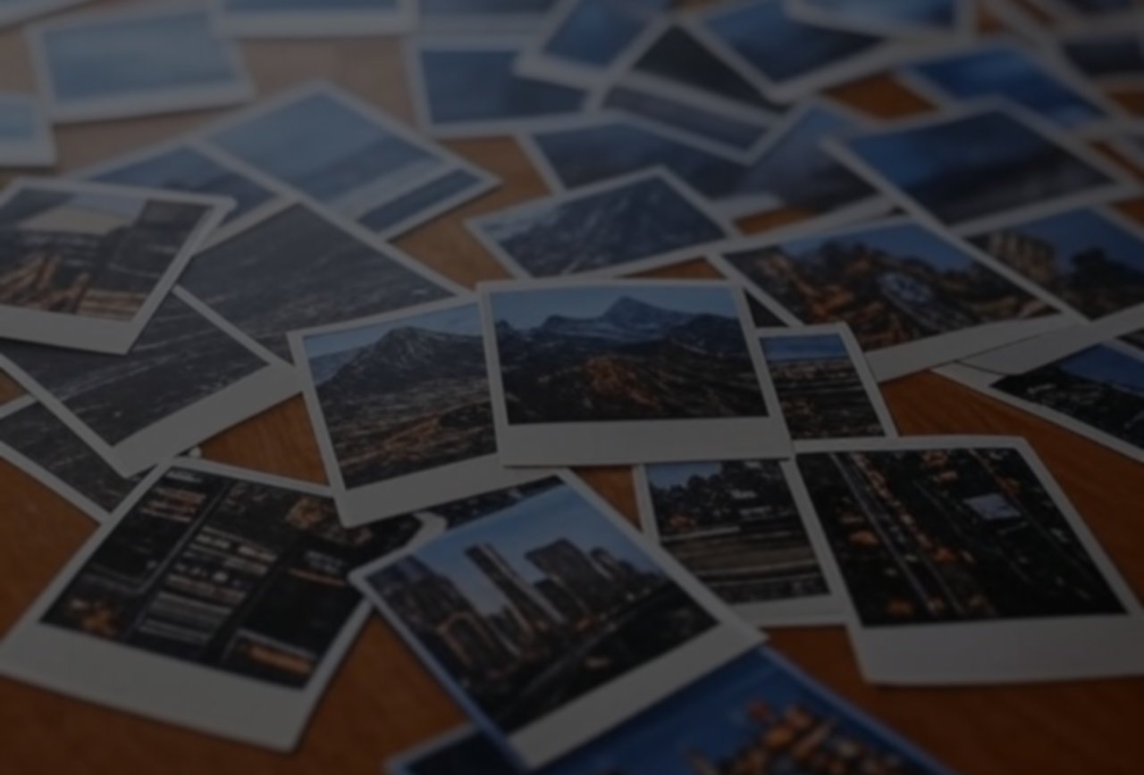 background image of photos thrown on a desk.